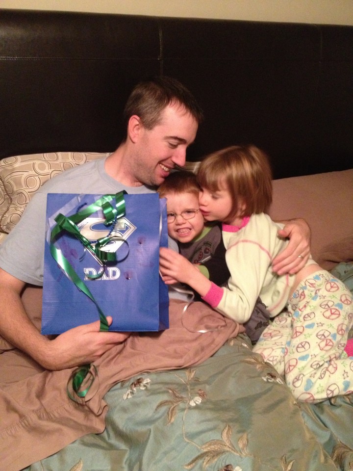 The kids giving their dad his birthday present.