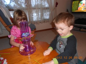 Abby & Aiden playing Kerplunk which they got for Christmas.