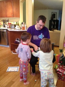 Aiden & Abby helping Dad open a present.