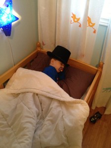 Aiden sleeping with his magician hat.