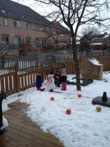 Dad, Abby & Aiden putting the finishing touches on their snowman