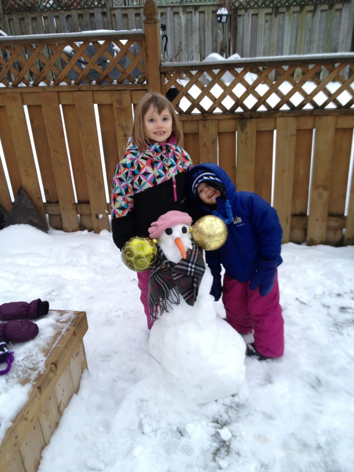 Abby & Aiden with the snowman that Abby made