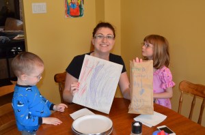Melissa holding up some of her gifts from Abby & Aiden
