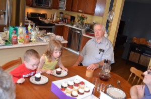 Abby & Aiden blowing out candles on the cupcakes