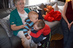 Aiden giving Macklan a hug, while Macklan giving Aiden a kiss.