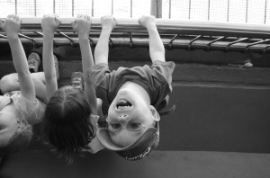 Aiden hanging upside off the railing at the Tower
