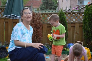 Sandra playing with Aiden & Abby in sandbox
