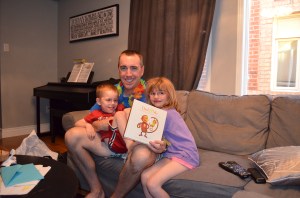 Peter holding gift from book he got from Abby & Aiden