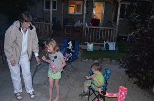 Jane helping Abby eat a roasted marshmallow 