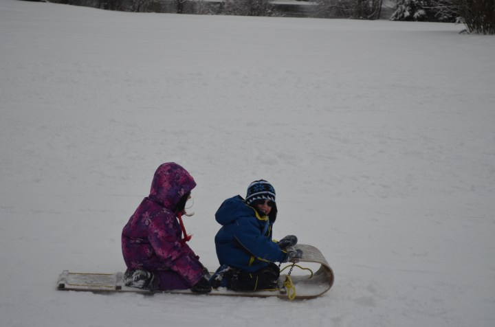 Abby & Aiden going by on their toboggan