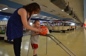 Melissa helping Aiden bowl
