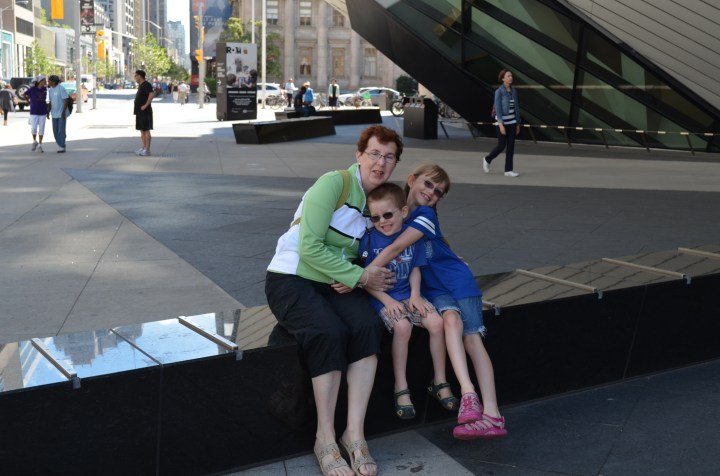 Grandma with Abby and Aiden in front of the ROM