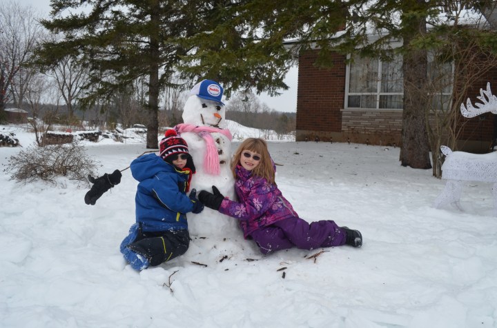 Abby and AIden with their Snowman at Mama and Papa's