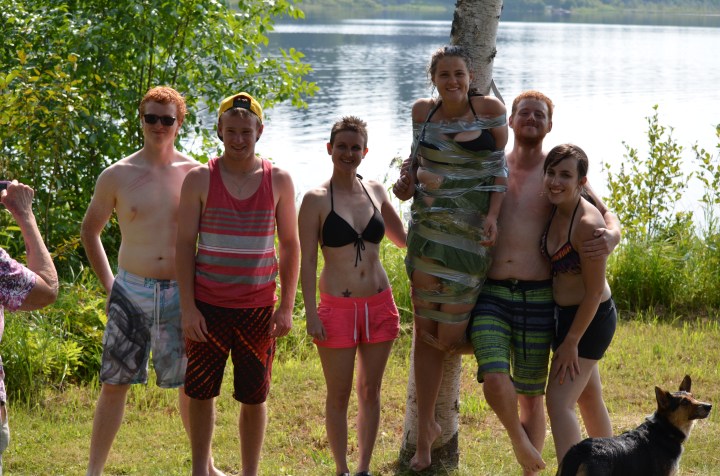 Lucas, Jordan, Shauna, Philip and Stephanie L. posing with Stephanie G. who they taped to the tree.