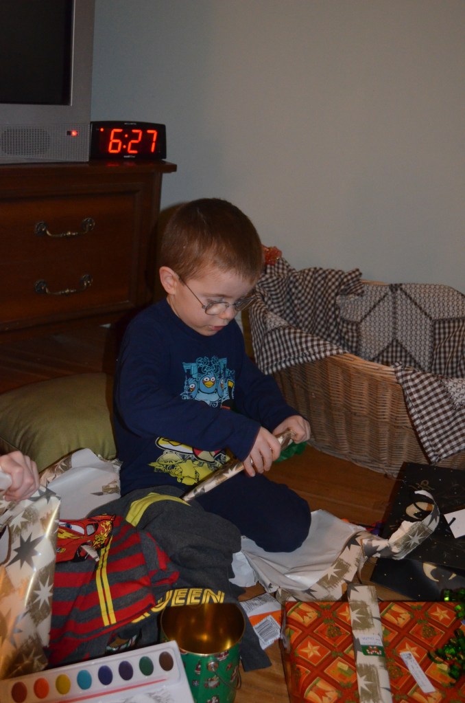 Aiden opening presents at Grandma and Grandpa's.