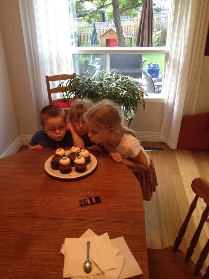 Aiden, Abby and Ava blowing out their cadles