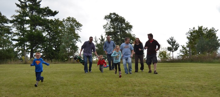 Aiden, Peter C, Macklan, Rob, Abby, Jason, Julie and Peter A. running down the hill and enjoying the day.