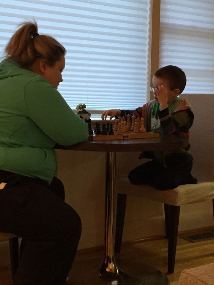 Aiden playing a game of chess with Auntie Megan on easter morning.