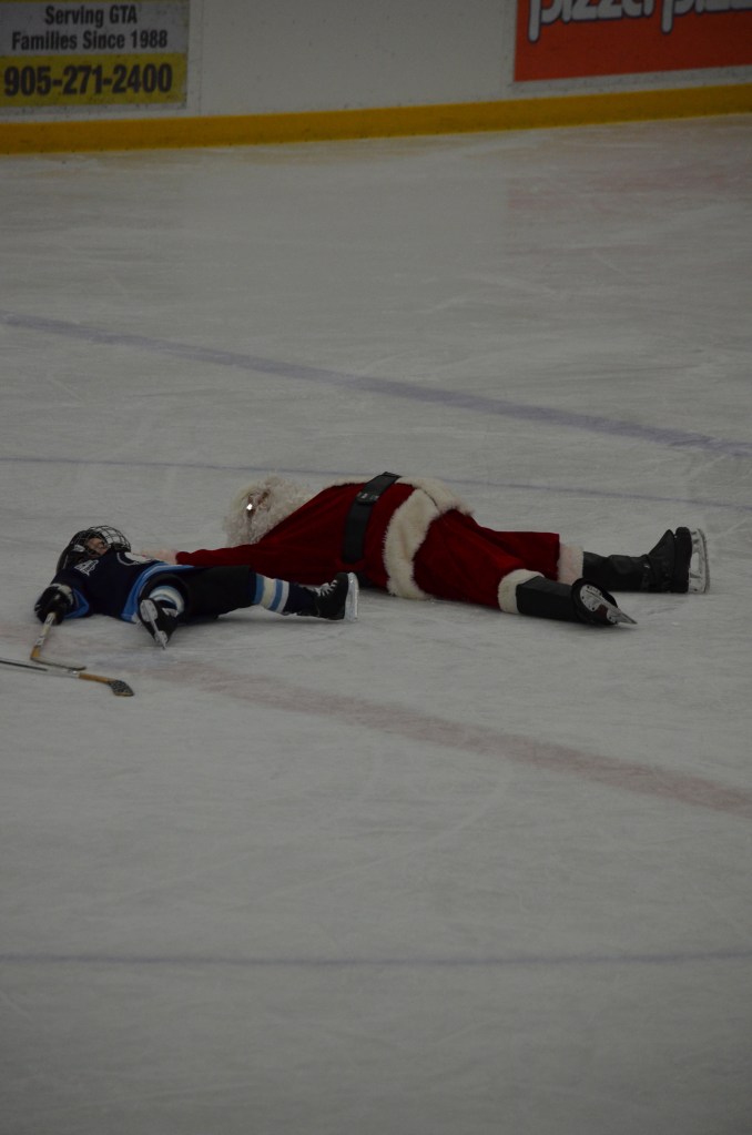 Aiden with Santa making snow angels.