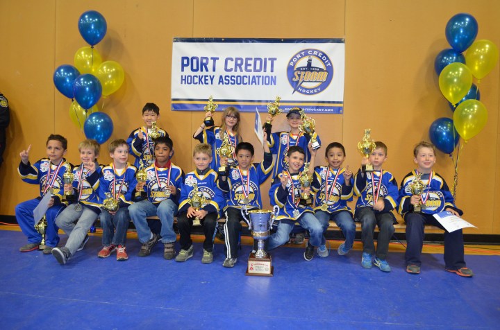 Abby and her team at the trophy banquet with their individual gold trophies.