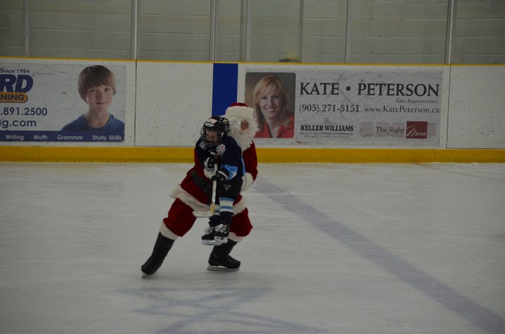 Aiden being carried around by Santa (Tom)