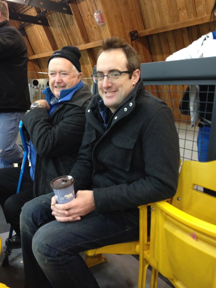 Uncle Rob and Papa cheering on Aiden at an early morning game.