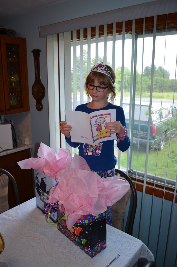 Abby opening up her present and Mama & Papa's