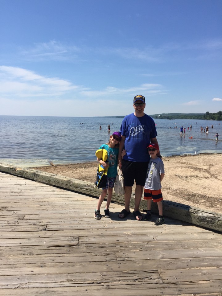 Abby & Aiden at beach with Lake Nipissing in the background